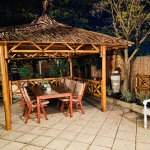 bamboo gazebo with table and chairs ready for hosting