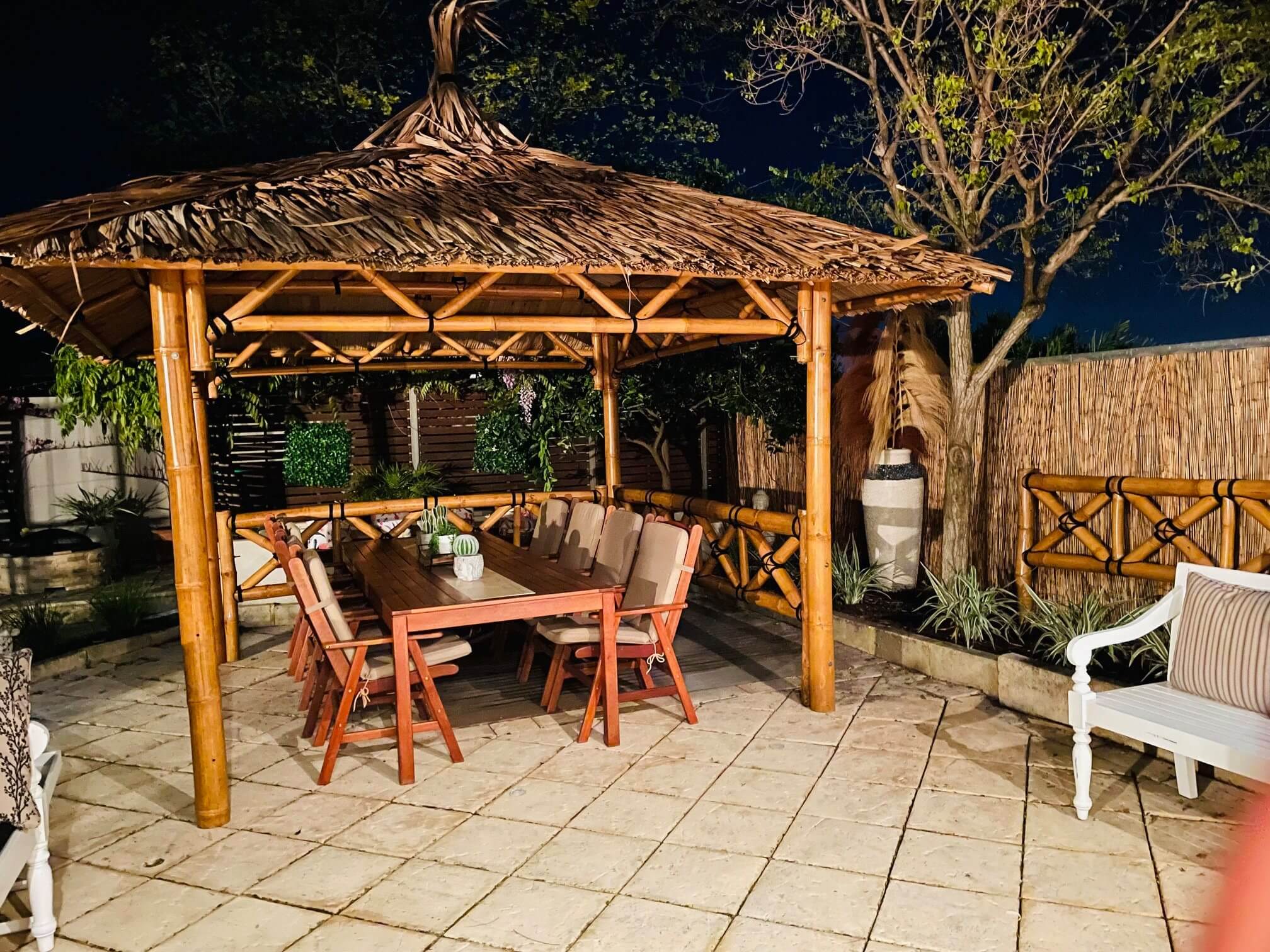 bamboo gazebo with table and chairs ready for hosting