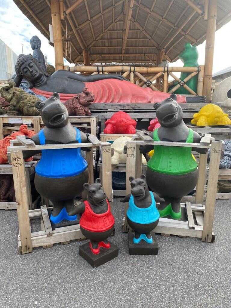 brightly coloured hippo garden statues in blue red and green